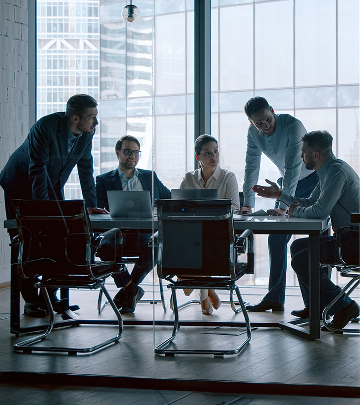 IQX Team in office setting discussing a capital project